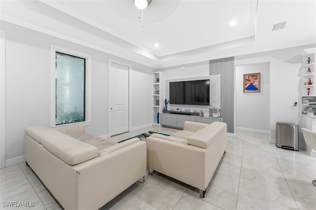 living room with ceiling fan and a tray ceiling