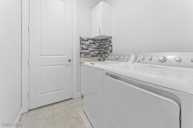 laundry area featuring cabinets and independent washer and dryer