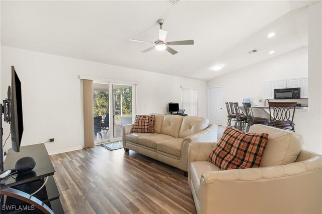 living room featuring dark wood-type flooring, lofted ceiling, and ceiling fan