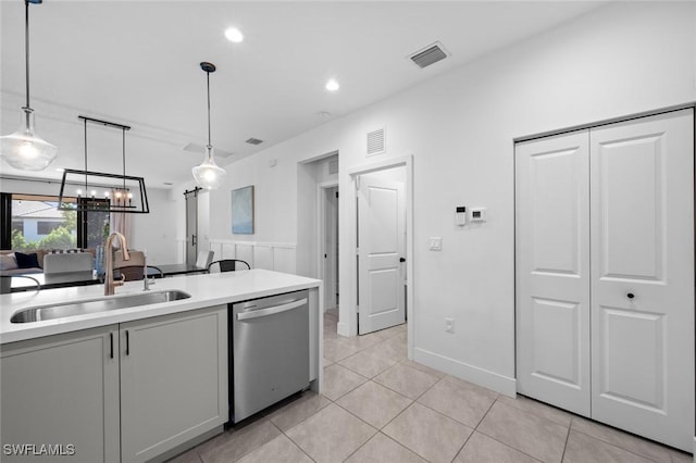 kitchen featuring dishwasher, pendant lighting, light tile patterned floors, gray cabinetry, and sink