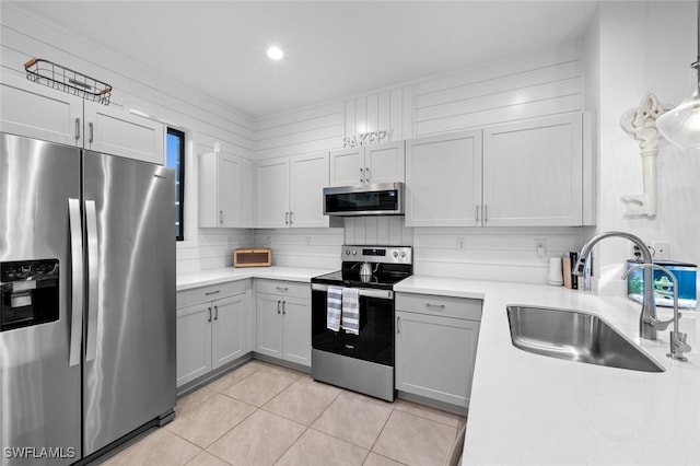 kitchen featuring stainless steel appliances, light tile patterned floors, sink, and tasteful backsplash