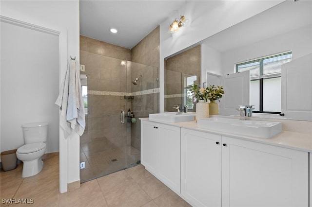 bathroom with toilet, an enclosed shower, vanity, and tile patterned floors