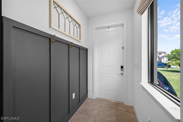 doorway featuring light tile patterned floors and plenty of natural light