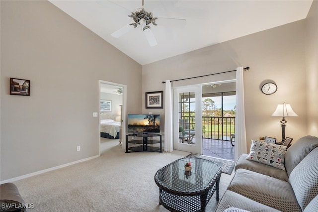 carpeted living room with ceiling fan and high vaulted ceiling