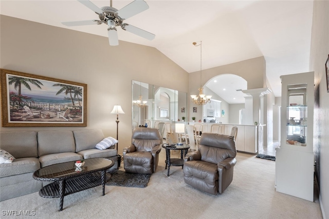 living room with high vaulted ceiling, ceiling fan with notable chandelier, light colored carpet, and ornate columns