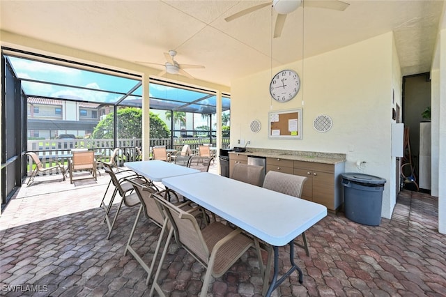 sunroom featuring ceiling fan