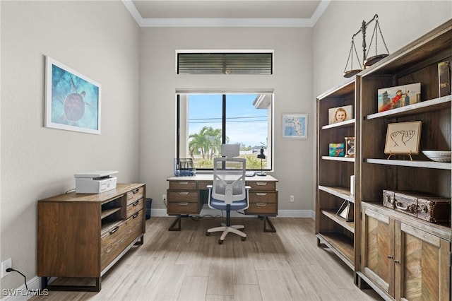 home office featuring ornamental molding and light hardwood / wood-style floors