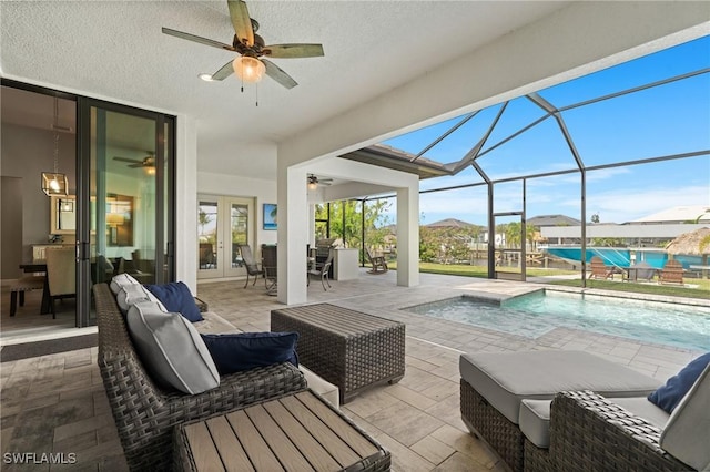 view of patio / terrace with ceiling fan, glass enclosure, and french doors