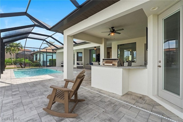 view of patio with grilling area, ceiling fan, area for grilling, and exterior bar