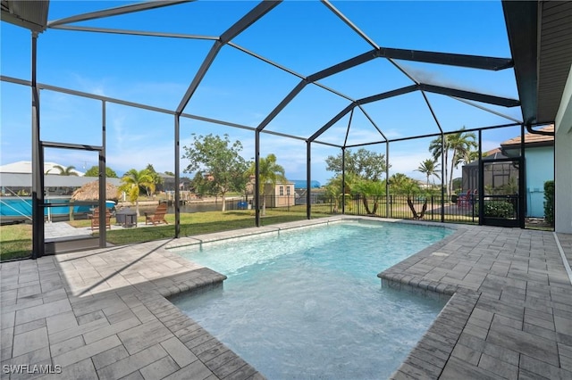 view of pool featuring glass enclosure and a patio area