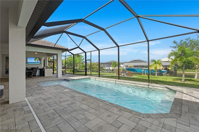 view of swimming pool featuring glass enclosure and a patio area