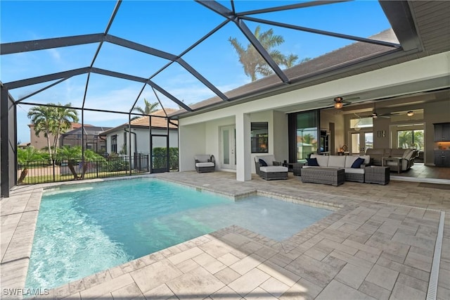 view of pool with a patio area, outdoor lounge area, a lanai, and ceiling fan