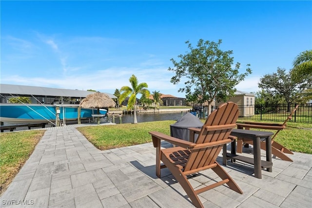 view of patio / terrace featuring a dock and a water view