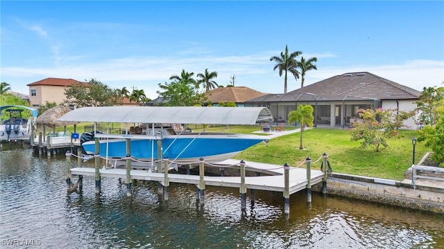 dock area with a water view, a lawn, and glass enclosure