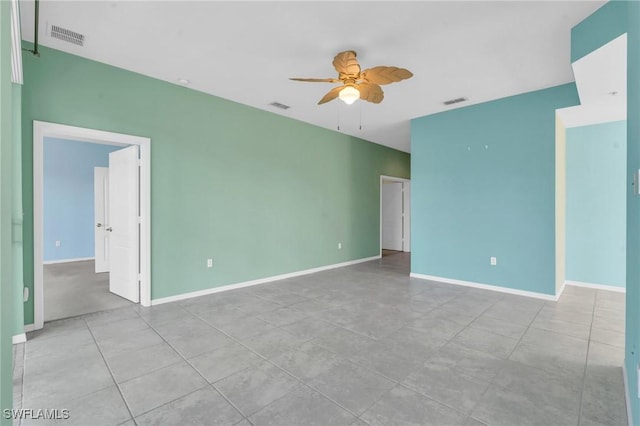 tiled empty room with ceiling fan