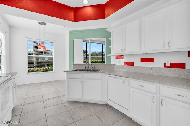 kitchen featuring white appliances, hanging light fixtures, light tile patterned floors, and white cabinets