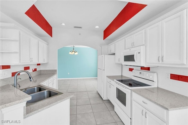 kitchen with white appliances, light stone counters, white cabinets, light tile patterned flooring, and sink