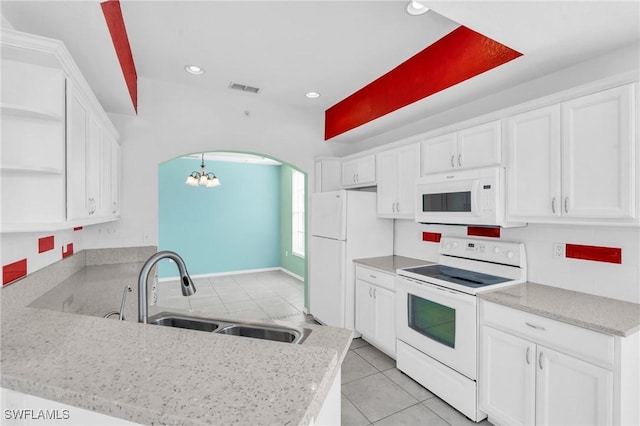 kitchen featuring sink, white cabinetry, white appliances, light tile patterned floors, and kitchen peninsula