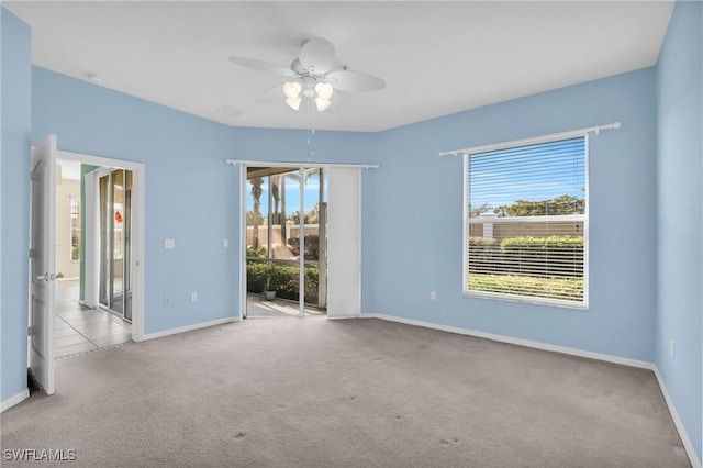 carpeted empty room featuring ceiling fan