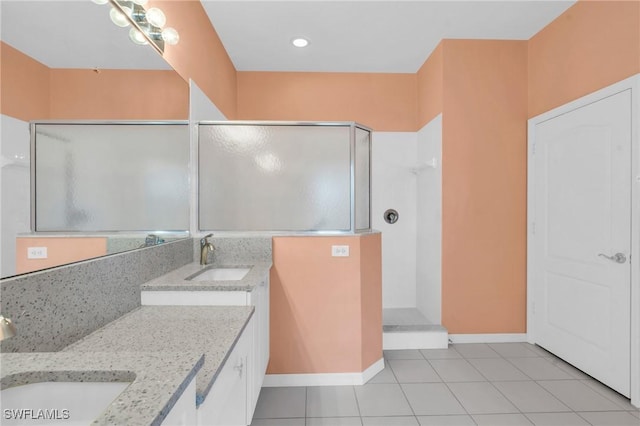 bathroom featuring tile patterned floors, walk in shower, and vanity