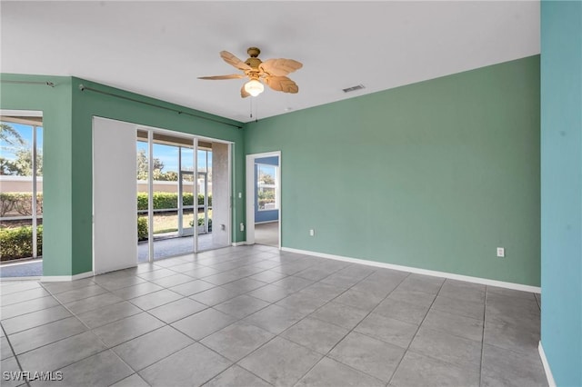 empty room featuring ceiling fan and light tile patterned floors