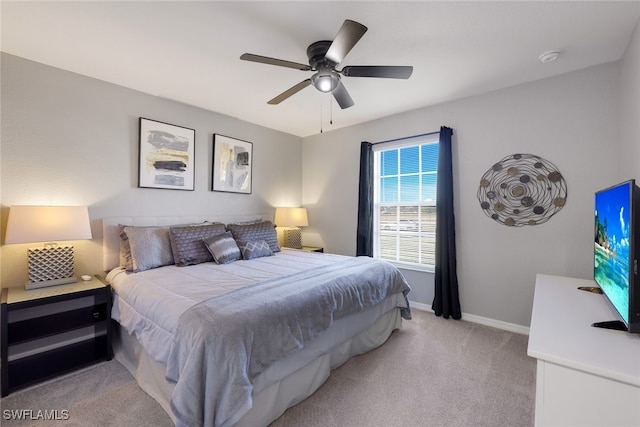 bedroom featuring light colored carpet and ceiling fan