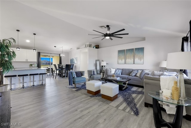 living room with ceiling fan and light hardwood / wood-style flooring