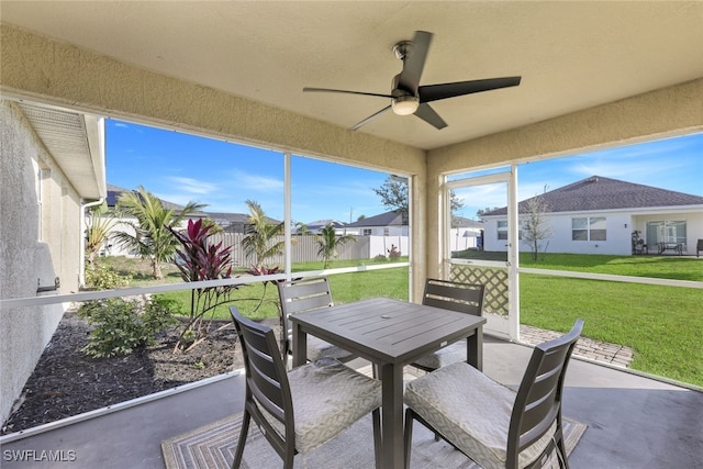 sunroom / solarium featuring ceiling fan