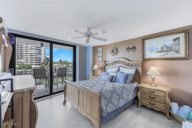 bedroom with access to outside, light wood-type flooring, floor to ceiling windows, and ceiling fan