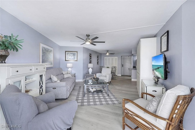 living room featuring ceiling fan and light hardwood / wood-style flooring