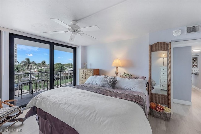 bedroom with light hardwood / wood-style floors, ceiling fan, access to outside, and expansive windows