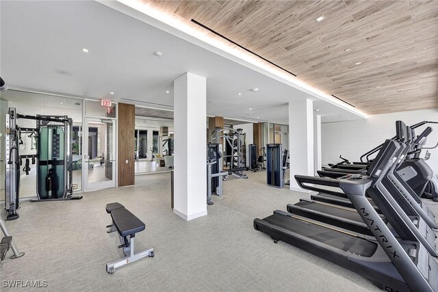 workout area with light colored carpet and wooden ceiling