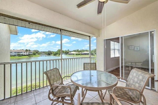 sunroom / solarium featuring ceiling fan, lofted ceiling, and a water view