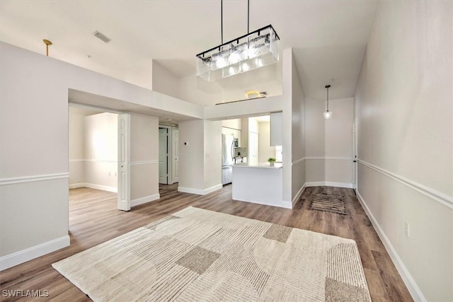 entryway with hardwood / wood-style flooring and a high ceiling