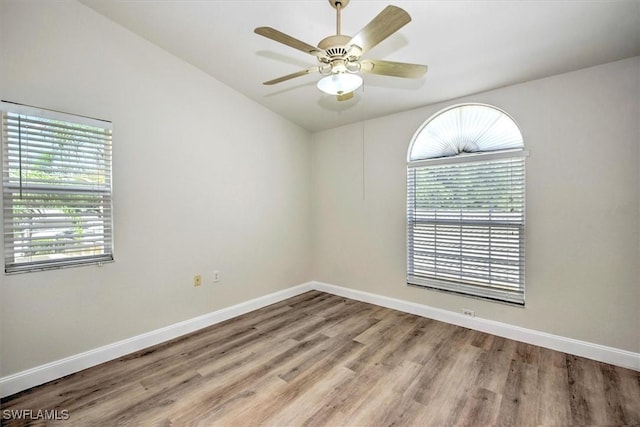 empty room with light wood-type flooring, ceiling fan, and lofted ceiling