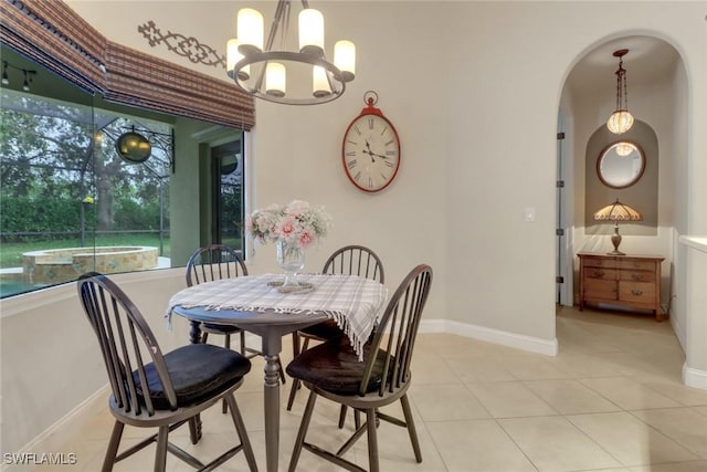 tiled dining space with an inviting chandelier