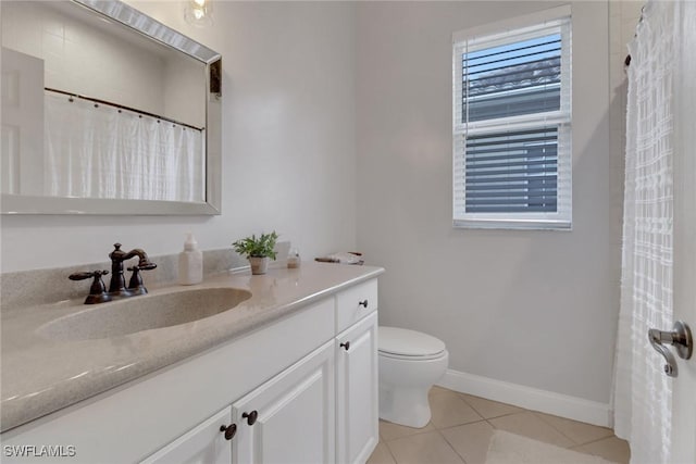 bathroom with tile patterned floors, vanity, and toilet