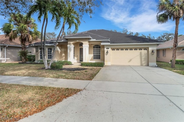 view of front of house with a front lawn and a garage