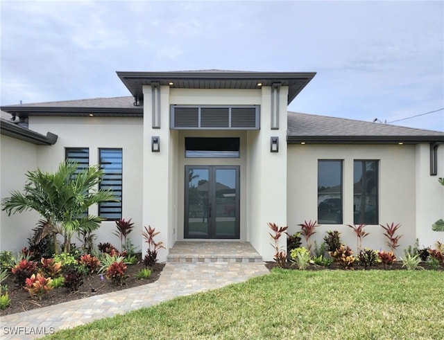 property entrance featuring french doors and a yard