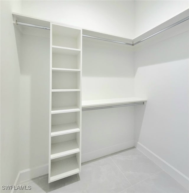 spacious closet featuring light tile patterned floors