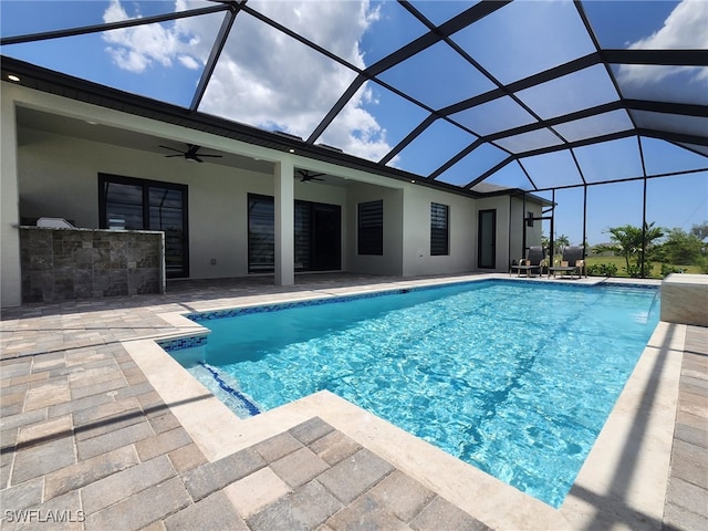 view of swimming pool featuring a lanai, a patio, and ceiling fan