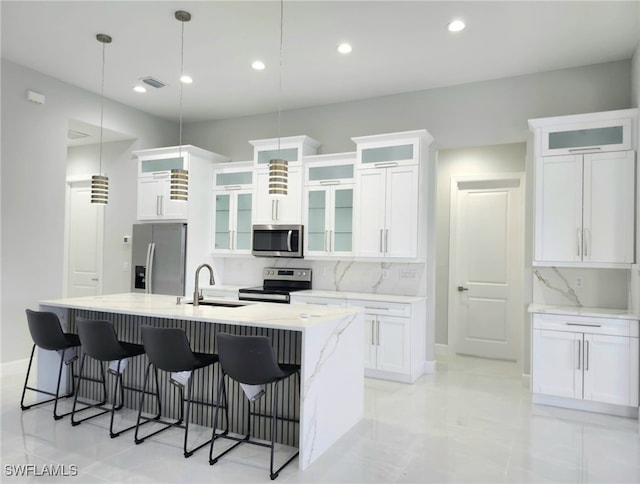 kitchen with decorative light fixtures, stainless steel appliances, backsplash, and sink