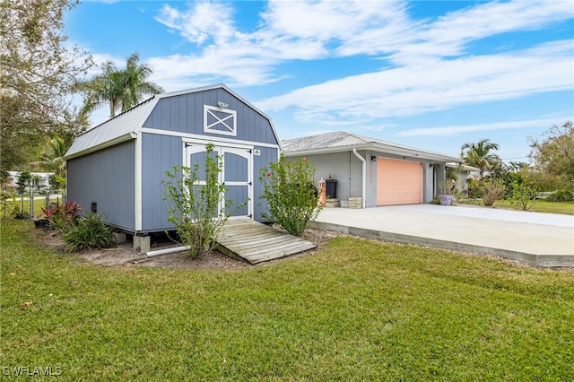 exterior space with a garage and a lawn