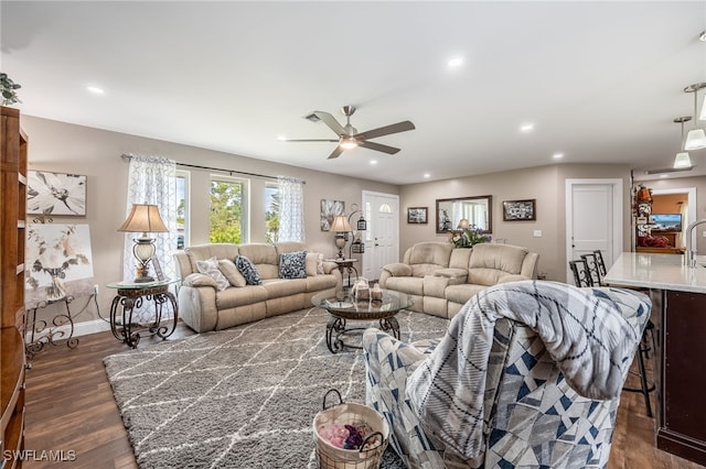 living room with ceiling fan and dark hardwood / wood-style floors