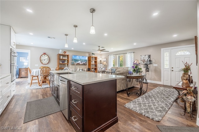 kitchen with ceiling fan, white cabinets, pendant lighting, and dark brown cabinetry