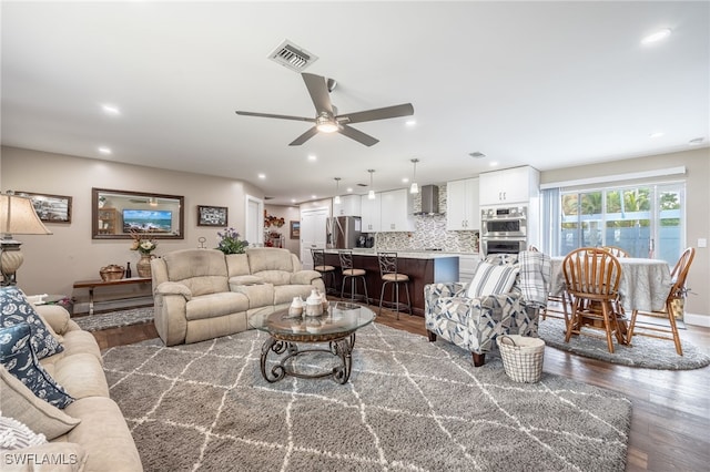 living room with ceiling fan and dark hardwood / wood-style floors