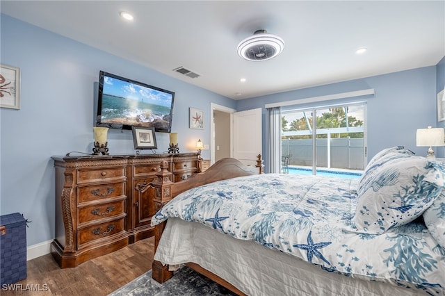 bedroom featuring access to exterior and dark hardwood / wood-style flooring