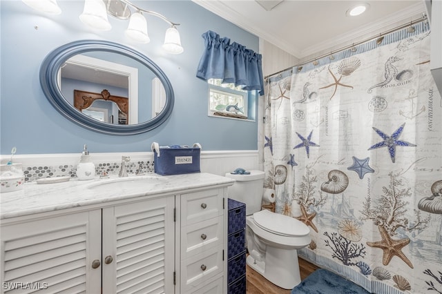 bathroom featuring toilet, vanity, hardwood / wood-style floors, crown molding, and curtained shower