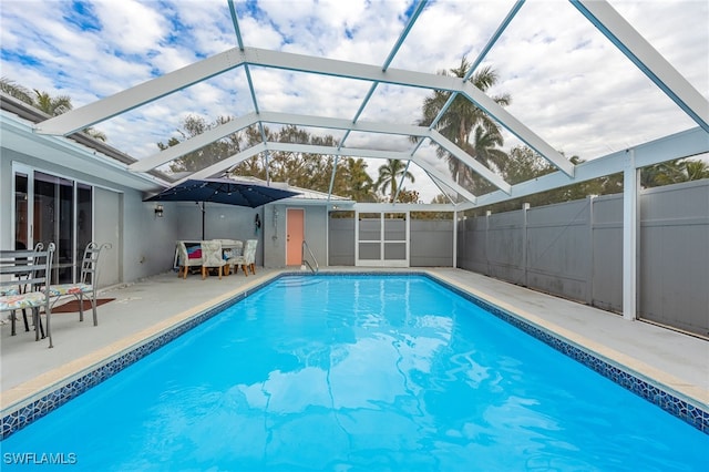 view of swimming pool with a lanai and a patio