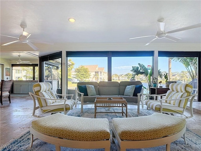 sunroom featuring ceiling fan